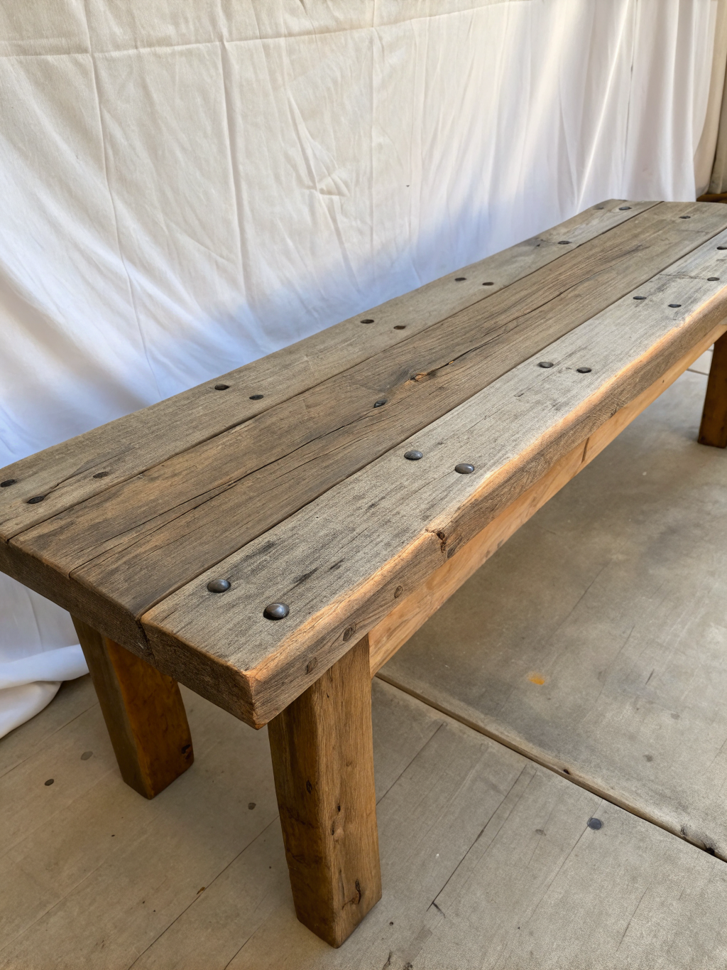 Reclaimed wood entryway bench with iron legs